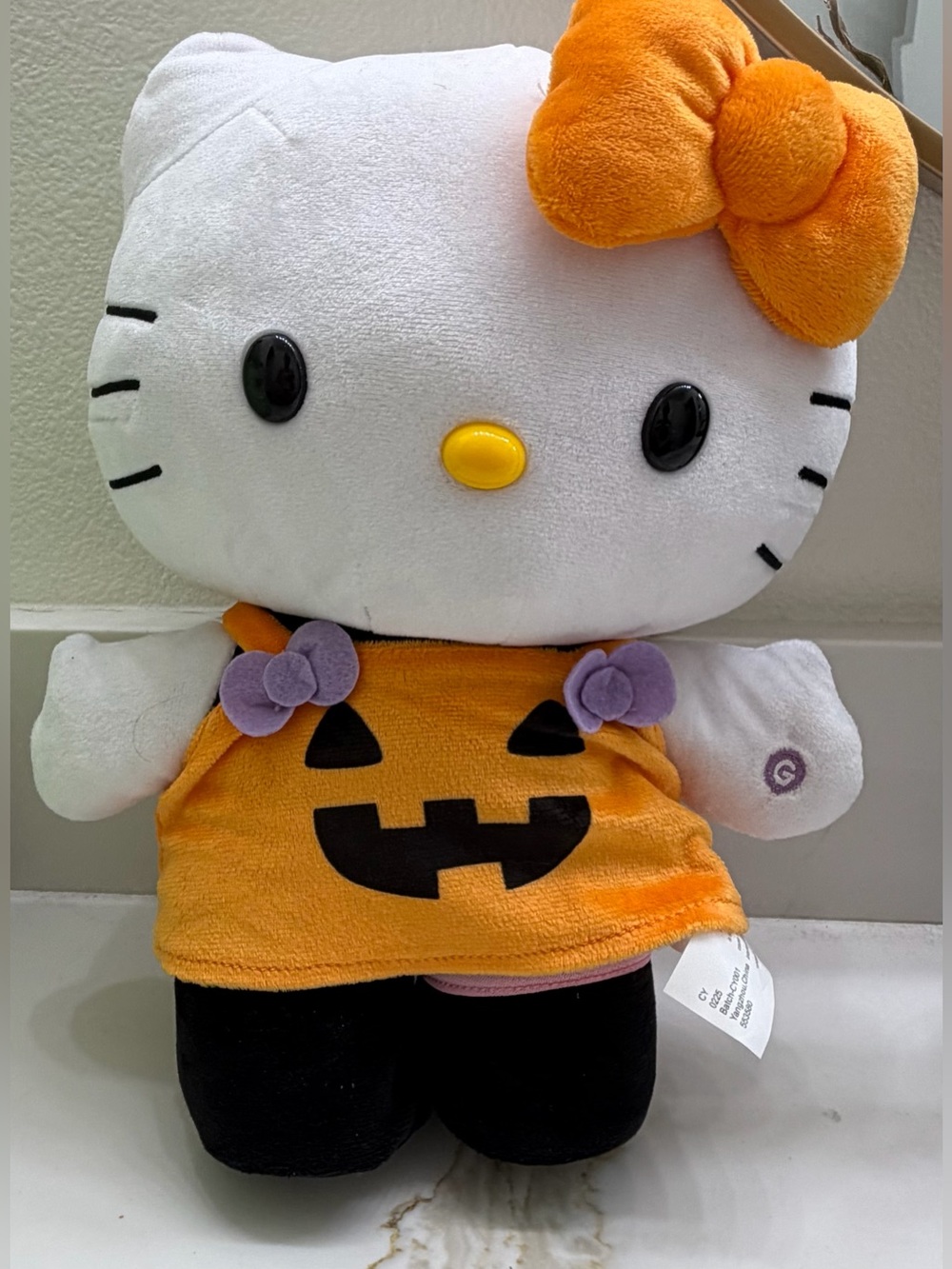 Dancing Hello Kitty Plush with Orange Outfit and Purple Accents